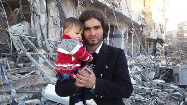 Abdulkafi Alhamdo with his daughter when they and hundreds of others were evacuated from Aleppo in December 2016. (Courtesy of Abdulkafi Alhamdo)