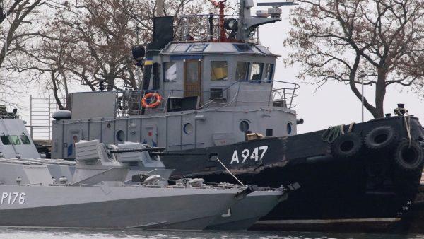 Seized Ukrainian ships, small armoured artillery ships and a tug boat, are seen anchored in a port of Kerch, Crimea, on Nov. 26, 2018. (Pavel Rebrov/Reuters)