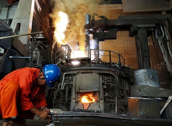 A man works in front of a furnace at a steel plant of Dalian Special Steel Co Ltd. in Dalian, Liaoning Province, China, on June 20, 2018. (Reuters)