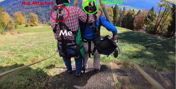An annotated image of the moment Chris Gursky launched off a Swiss hillside on a hang-glider without his harness attached in Oct. 2018. (Screengrab/YouTube)