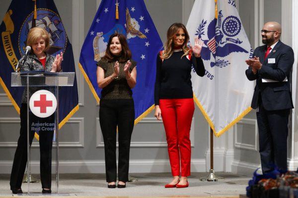 First lady Melania Trump, waves as she is acknowledged by, from left, Gail McGovern, President of the American Red Cross, Karen Pence, and Koby Langley, Senior Vice President of the American Red Cross at the Red Cross in Washington, Nov. 27, 2018. (AP Photo/Carolyn Kaster)