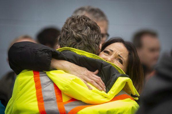 Workers at the General Motors plant in Oshawa hug each other before a meeting with Unifor president Jerry Dias on Nov. 26, 2018, after news that the plant will close in December 2019. (The Canadian Press/Eduardo Lima)