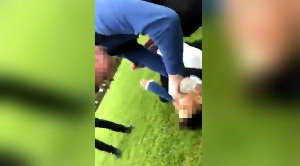 A schoolboy at a South Yorkshire school is captured on video bullying another pupil, pouring water in his mouth as he pins him down. (Screengrab/Twitter)
