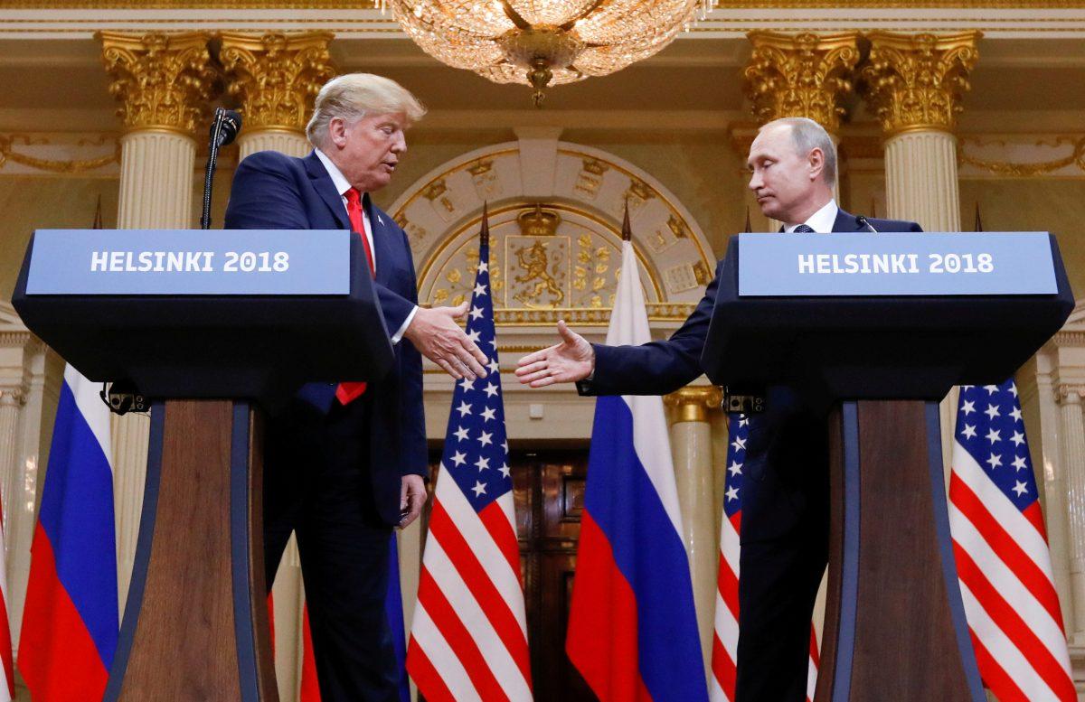 President Donald Trump and Russia's President Vladimir Putin shake hands during a joint news conference after their meeting in Helsinki, Finland, on July 16, 2018. (Kevin Lamarque/Reuters)