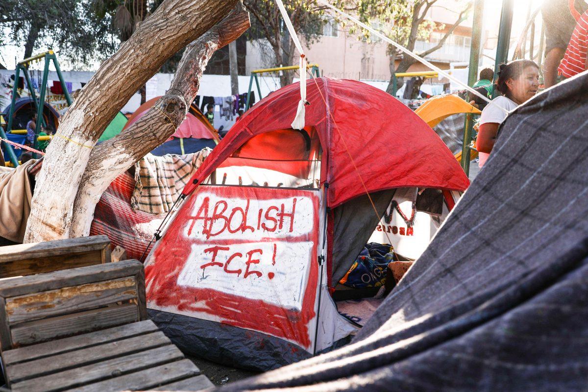 A tent with "Abolish ICE" painted on the side is seen in the migrant camp at Benito Juarez sports complex in Tijuana, Mexico, on Nov. 26, 2018. (Charlotte Cuthbertson/The Epoch Times)