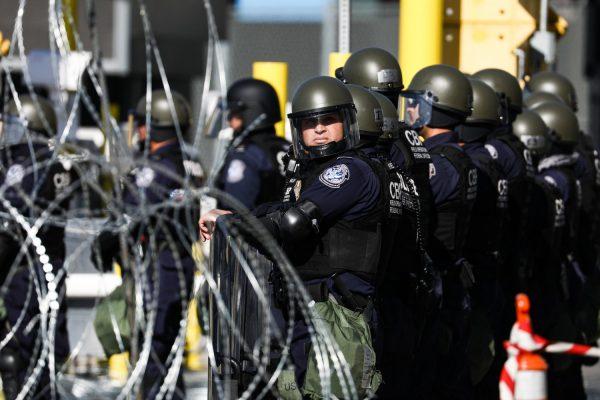 U.S. Customs and Border agents prepare for a rush of migrants near the east pedestrian entrance at the San Ysidro border crossing in Tijuana, Mexico, on Nov. 25, 2018. (Charlotte Cuthbertson/The Epoch Times)