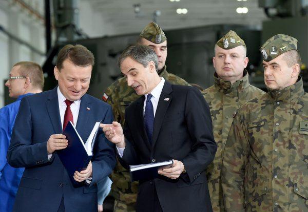 Polish Defence Minister Mariusz Blaszczak (L) speaks with the US Ambassador to Poland Paul W Jones after signing a contract to buy a US-made Patriot anti-missile system in Warsaw, on March 28, 2018. (Janek Skarzynski/AFP/Getty Images)