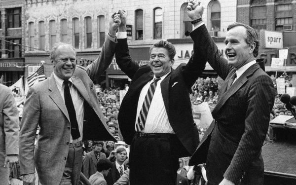 In this Nov. 3, 1980, file photo, former President Gerald Ford (L) lends his support to Republican presidential candidate Ronald Reagan and his running mate George H.W. Bush (R) in Peoria, Ill. (AP Photo/File)