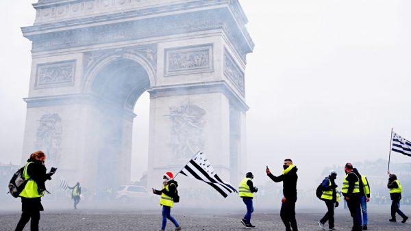 Tear gas floats in the air near the Arc de Triomphe as protesters wearing yellow vests, symbol of French drivers' protest against higher diesel taxes, demonstrate in Paris, France, on Dec. 1, 2018. (Stephane Mahe/Reuters)