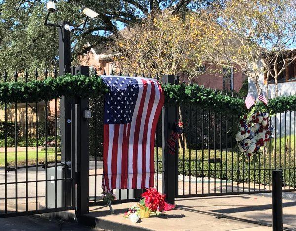 A flag is draped over the gate to the neighborhood of the home of former President George H.W. Bush, a day after he passed away in Houston, Texas on Dec. 1, 2018. (Gary McWilliams/Reuters)