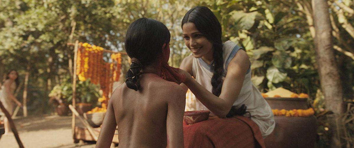 Rohan Chand (L) and Freida Pinto in "Mowgli: Legend of the Jungle." (Netflix/Warner Bros. Entertainment Inc.)