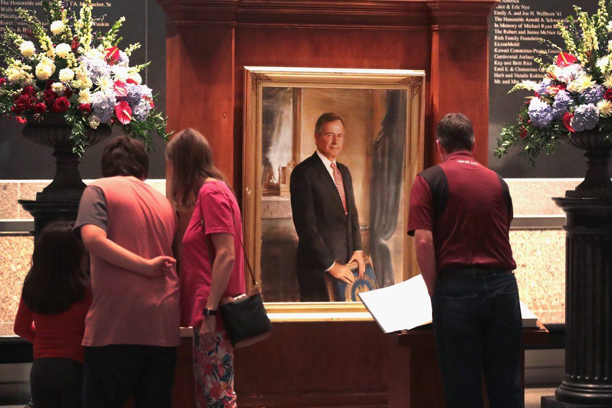 Visitors sign a guest book at the George H.W. Bush Presidential Library Center in College Station, Tex., on Dec. 1, 2018. (Scott Olson/Getty Images)