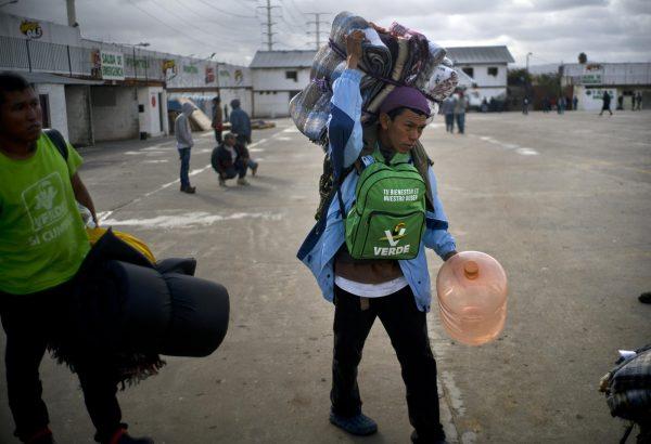 Honduran migrants arrive at a new shelter, in Tijuana, Mexico, on Nov. 30, 2018. (AP Photo/Ramon Espinosa)