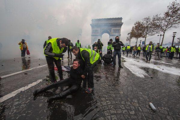 A protester is wounded by a water cannon as she clashes with riot police near the Arc de Triomphe in Paris, on Dec. 1, 2018. (Veronique de Viguerie/Getty Images)