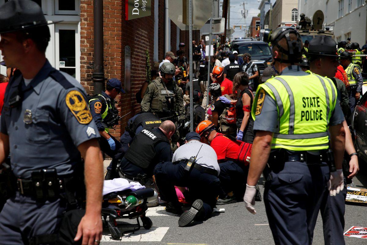 Rescue workers assist people who were injured when a car drove through a group of counter protestors at the "Unite the Right" rally Charlottesville, Va., U.S., Aug. 12, 2017. (Joshua Roberts/Reuters)