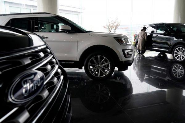 A woman looks at Ford cars at a dealer shop in Shanghai, China on April 5, 2018. (Aly Song/Reuters)