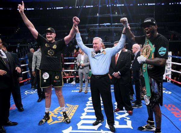 Tyson Fury and Deontay Wilder with referee Jack Reiss after fighting to a draw during the WBC Heavyweight Championship in Los Angeles, on Dec. 1, 2018. (Harry How/Getty Images)