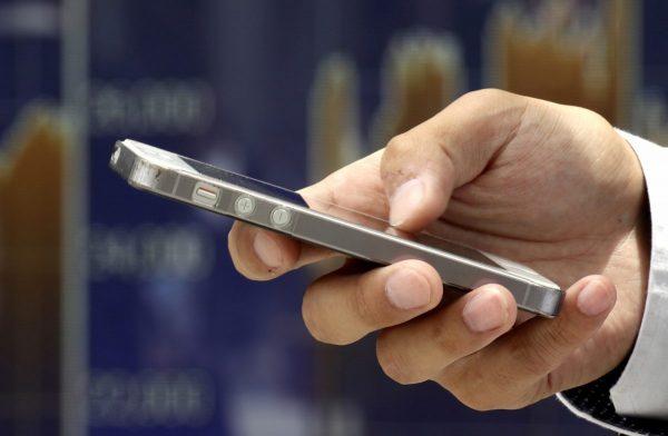 A man uses a smartphone in a file photo. (Shizuo Kambayashi/AP)