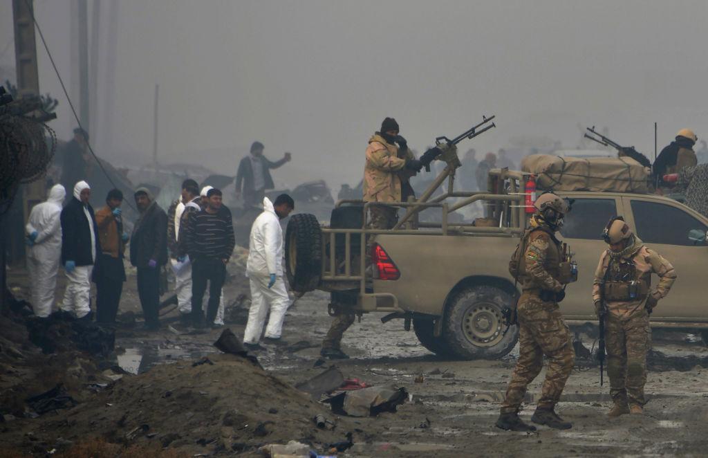 Afghan security forces and investigators gather at the site of a suicide bomb attack outside a British security firm's compound in Kabul, Afghanistan, a day after the blast on Nov. 29, 2018. Noorullah Shirzada/AFP/Getty Images)