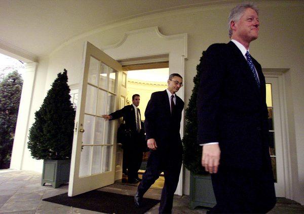 President Bill Clinton (R), his chief of staff John Podesta (C), and his aid Doug Band (L), leave the Oval Office of the White House for the last time on Jan. 20, 2001. (STEPHEN JAFFE/AFP/Getty Images)