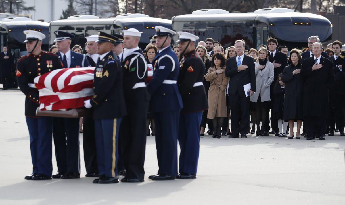 Former President George W. Bush watches as the flag-draped casket of former President George H.W. Bush is carried by a joint services military honor guard to Special Air Mission 41 after a state funeral at Joint Base Andrews, Md., on Dec. 5, 2018. (Alex Brandon - Pool/Getty Images)