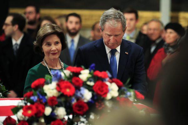 Former President George W. Bush and former first lady Laura Bush pay their respect to his father former President George H.W. Bush as he lie in state at the U.S. Capitol in Washington DC, Dec. 4, 2018. (AP Photo/Manuel Balce Ceneta)