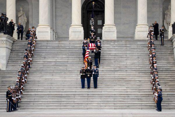 A U.S. military honor guard carries the flag-draped casket of the late former President George H.W. Bush down the steps of the U.S. Capitol in Washington, on Dec. 5, 2018. (Drew Angerer/Getty Images)