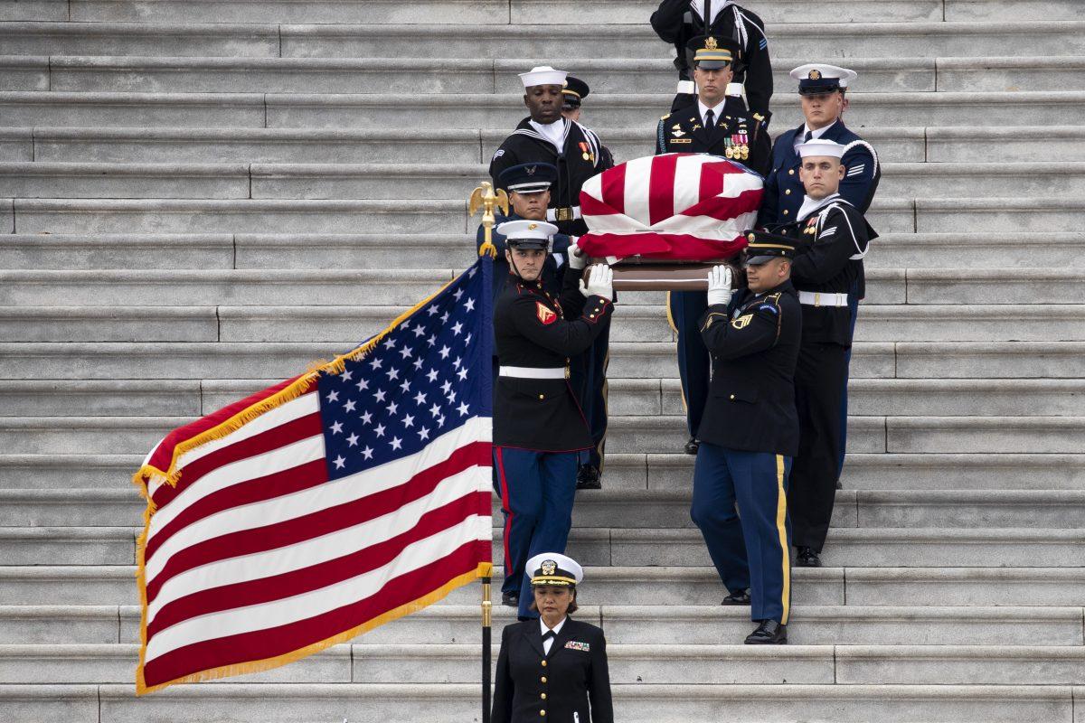 A U.S. military honor guard carries the flag-draped casket of the late former President George H.W. Bush down the steps of the U.S. Capitol, December 5, 2018 in Washington, DC. President Bush will be buried at his final resting place at the George H.W. Bush Presidential Library at Texas A&M University in College Station, Texas. (Drew Angerer/Getty Images)