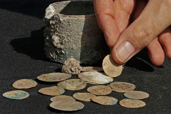 Ancient gold coins and an earring recently uncovered at an excavation site in the Israeli Mediterranean town of Caesarea, on Dec. 3, 2018. (Jack Guez/AFP/Getty Images)