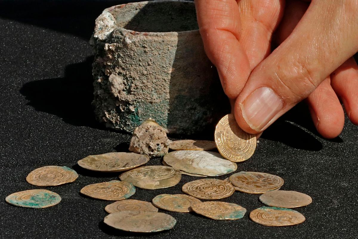A picture taken on December 3, 2018, shows ancient gold coins and an earring recently uncovered at an excavation site in the Israeli Mediterranean town of Caesarea.  (JACK GUEZ/AFP/Getty Images)