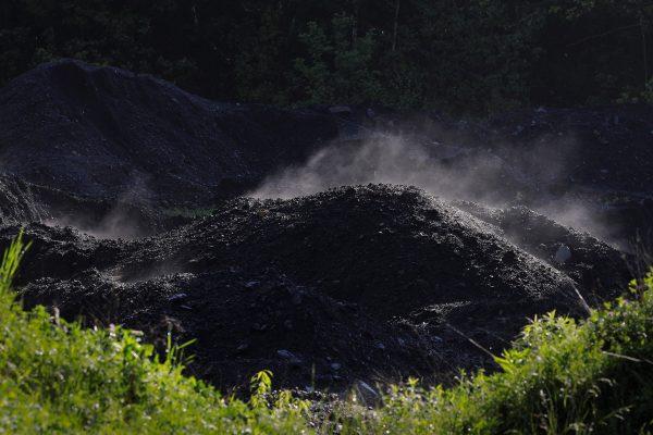 Steam rises from a pile of coal at a mine in Bishop, W. Va., on May 19, 2018. (Brian Snyder/Reuters)