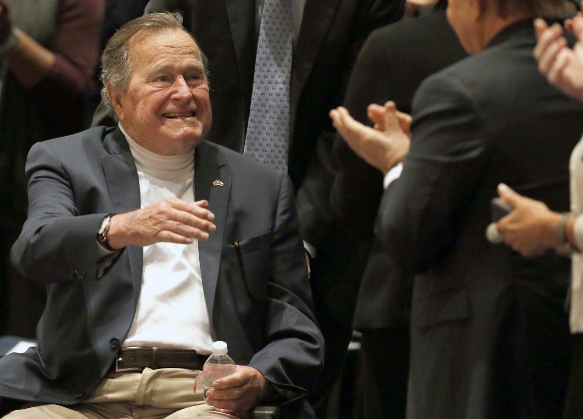 Former President George H.W. Bush acknowledges the crowd at his presidential library before his son former President George W. Bush discusses his new book "41: A Portrait of My Father" in College Station, Texas. (Bob Daemmrich/Texas Tribune via AP, Pool, File)