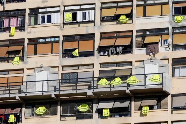 Yellow vests are hung outside windows of an apartment building in support of the "yellow vests" movement in Marseille, France, on Dec. 7, 2018. (Jean-Paul Pelissier/Reuters)