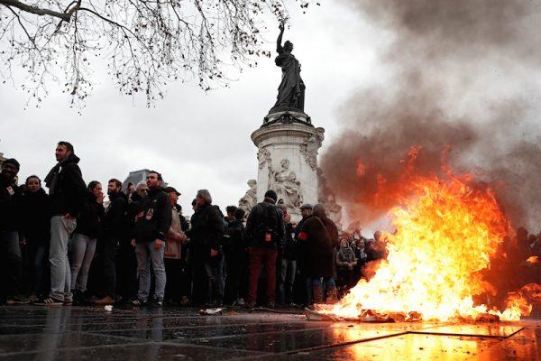 A trash bin burns as youths and high school students attend a demonstration to protest against the French government's reform plan, in Paris, France, on Dec. 7, 2018. (Benoit Tessier/Reuters)
