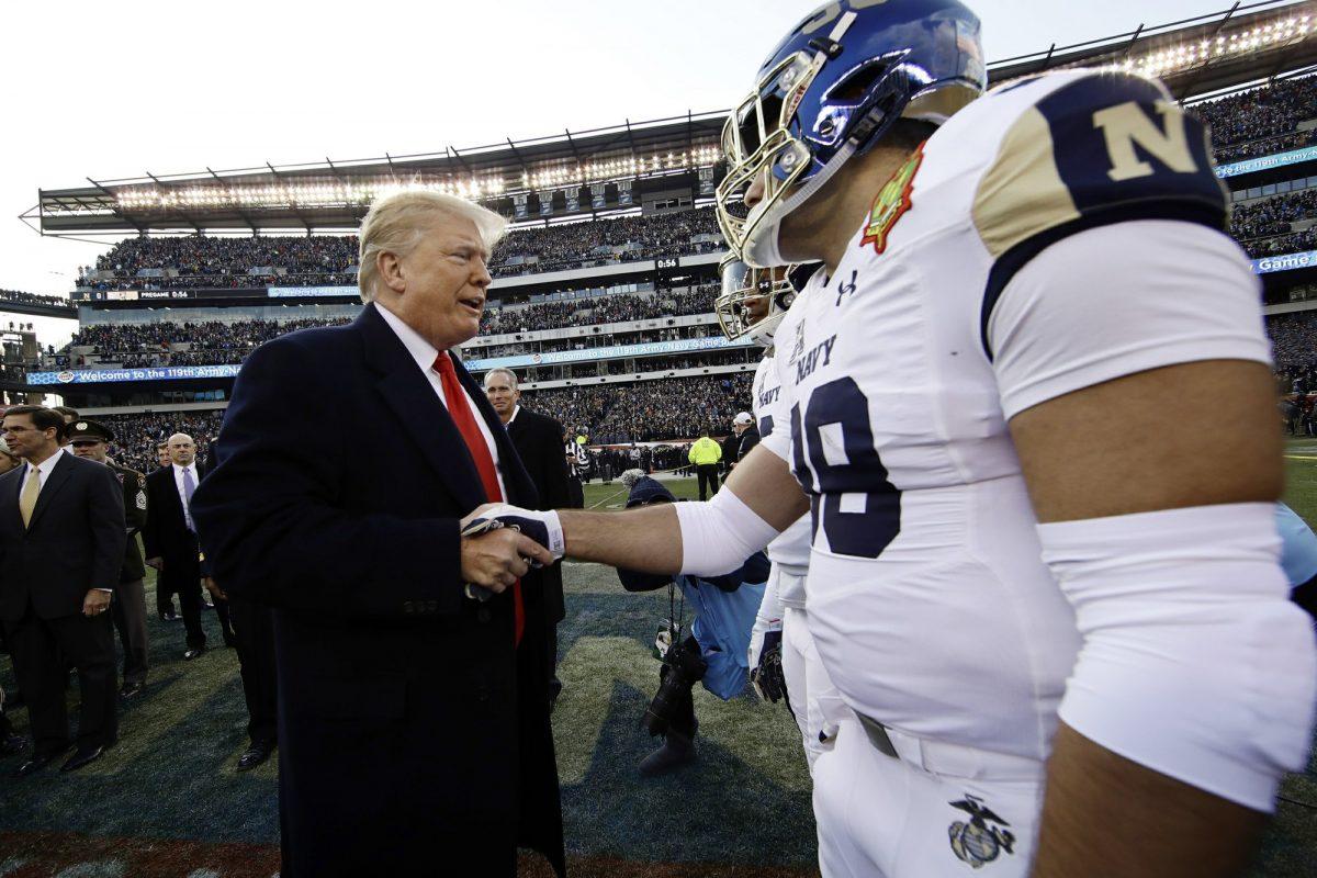 President Donald Trump meets with Navy player Anthony Gargiulo ahead of an NCAA college football game between Army and Navy, Dec. 8, 2018, in Philadelphia. (Matt Rourke/AP Photo)