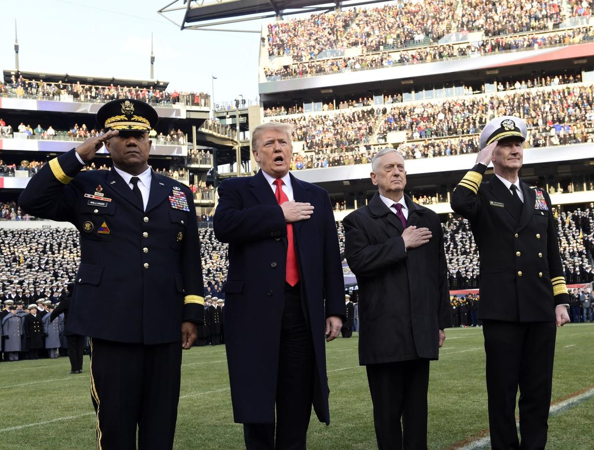 President Donald Trump, second from left, is joined by, from left, West Point Superintendent Lt. Gen. Darryl A. Williams, Defense Secretary Jim Mattis and Naval Academy Superintendent Vice Adm. Ted Carter, during the playing of the national anthem before the start of the Army-Navy NCAA college football game in Philadelphia, on Dec. 8, 2018. (AP Photo/Susan Walsh)