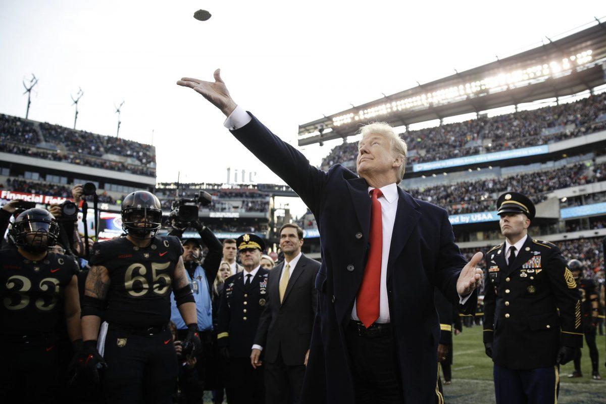 President Donald Trump tosses the coin before the Army-Navy NCAA college football game, on  Dec. 8, 2018, in Philadelphia. (Matt Rourke/AP Photo)