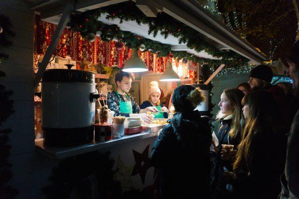 Freshly deep-fried fritule, traditional Christmastime Croatian doughnuts, are a popular market snack. (Crystal Shi/The Epoch Times)