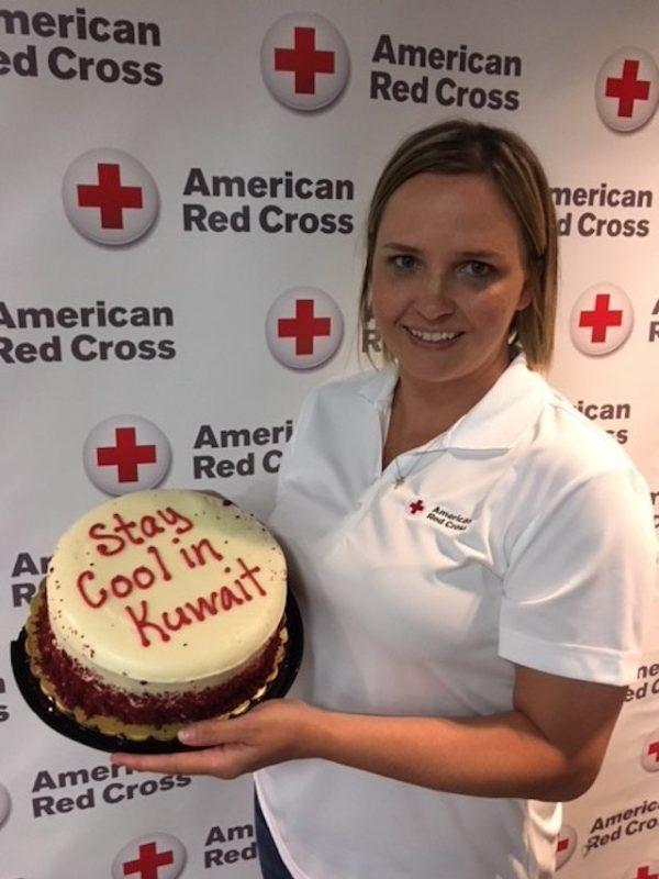 Katrina Gonzalez with a "Stay Cool in Kuwait" cake. Gonzalez has been striving to make Camp Buehring feel more like home, particularly during the holidays. (Courtesy of the American Red Cross)