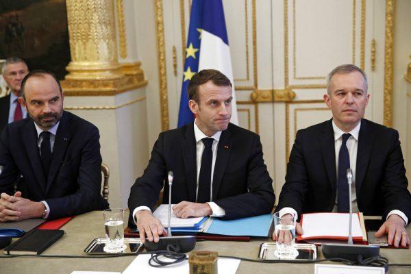 French President Emmanuel Macron, center, French Prime Minister Edouard Philipppe, left, and Environment Minister Francois de Rugy meet with representatives of trade unions, employers' organizations and local elected officials at the Elysee Palace in Paris, Monday, Dec.10 2018. (Yoan Valat, Pool via AP)