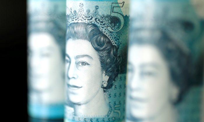 Pound Tumbles to 20-month Low After Britain’s May Aborts Brexit Vote