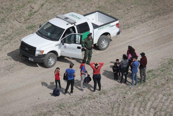 Asylum seekers turn themselves in to a Border Patrol agent after crossing from Mexico into the United States in Mission, Texas, on Nov. 7, 2018. (John Moore/Getty Images)