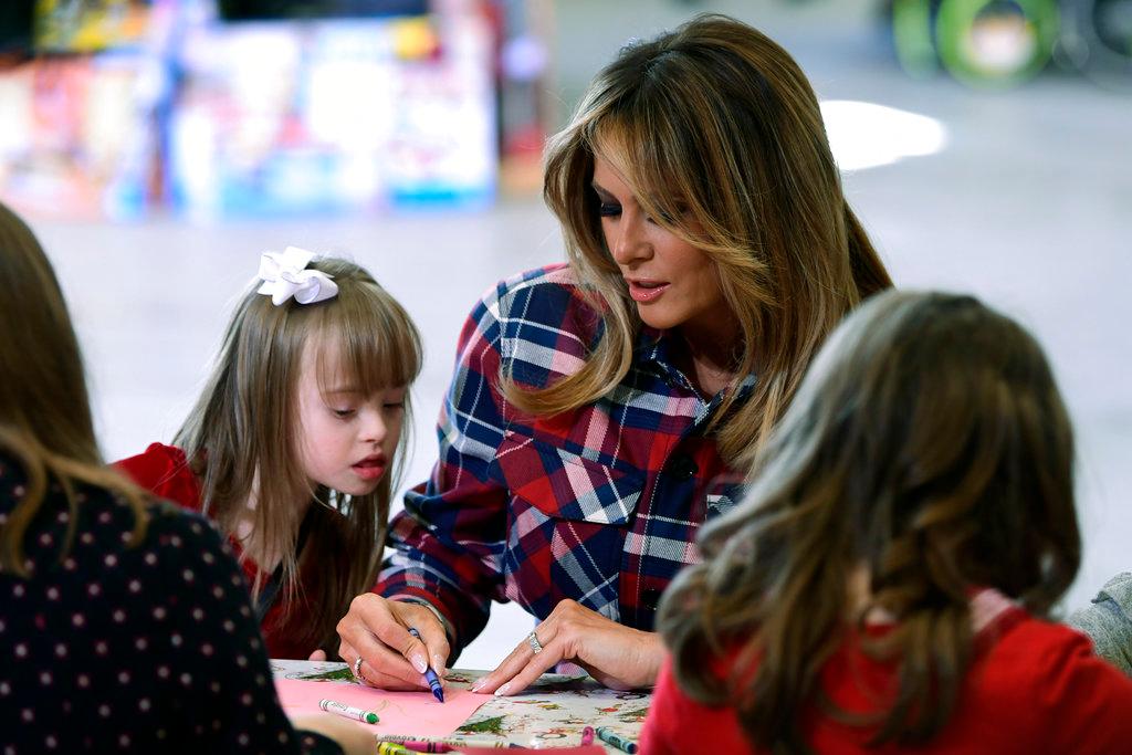 First lady Melania Trump colors with Jackie Rodriguez, 9, during a Toys for Tots event at Joint Base Anacostia-Bolling in Washington, on Dec. 11, 2018. (Susan Walsh/AP Photo)