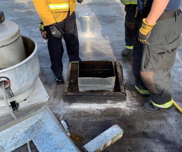 Firefighters stand at the roof vent where a man was trapped at a vacant Chinese restaurant in California on Dec. 12, 2018. (Alameda County Sheriff)