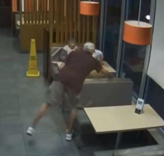 The man can be seen reaching in to take the woman’s purse at the McDonald’s in Okeechobee, Florida (Okeechobee Police Department)