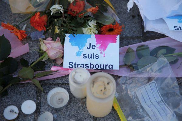 The message "I am Strasbourg" is seen among flowers and candles at the Place Kleber in tribute to the victims of the deadly shooting in Strasbourg, France, on Dec. 13, 2018. (Reuters/Vincent Kessler)