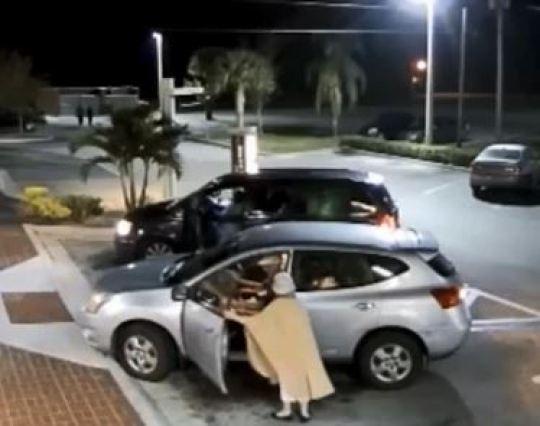 She tries to open the door before the man hits reverse. (Okeechobee Police Department)