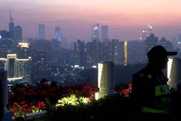A security guard stands at a viewing platform overlooking the central business area ahead of the 40th anniversary of China's reform and opening up in Shenzhen, Guangdong Province, China on Dec. 4, 2018. (Thomas Suen/Reuters)