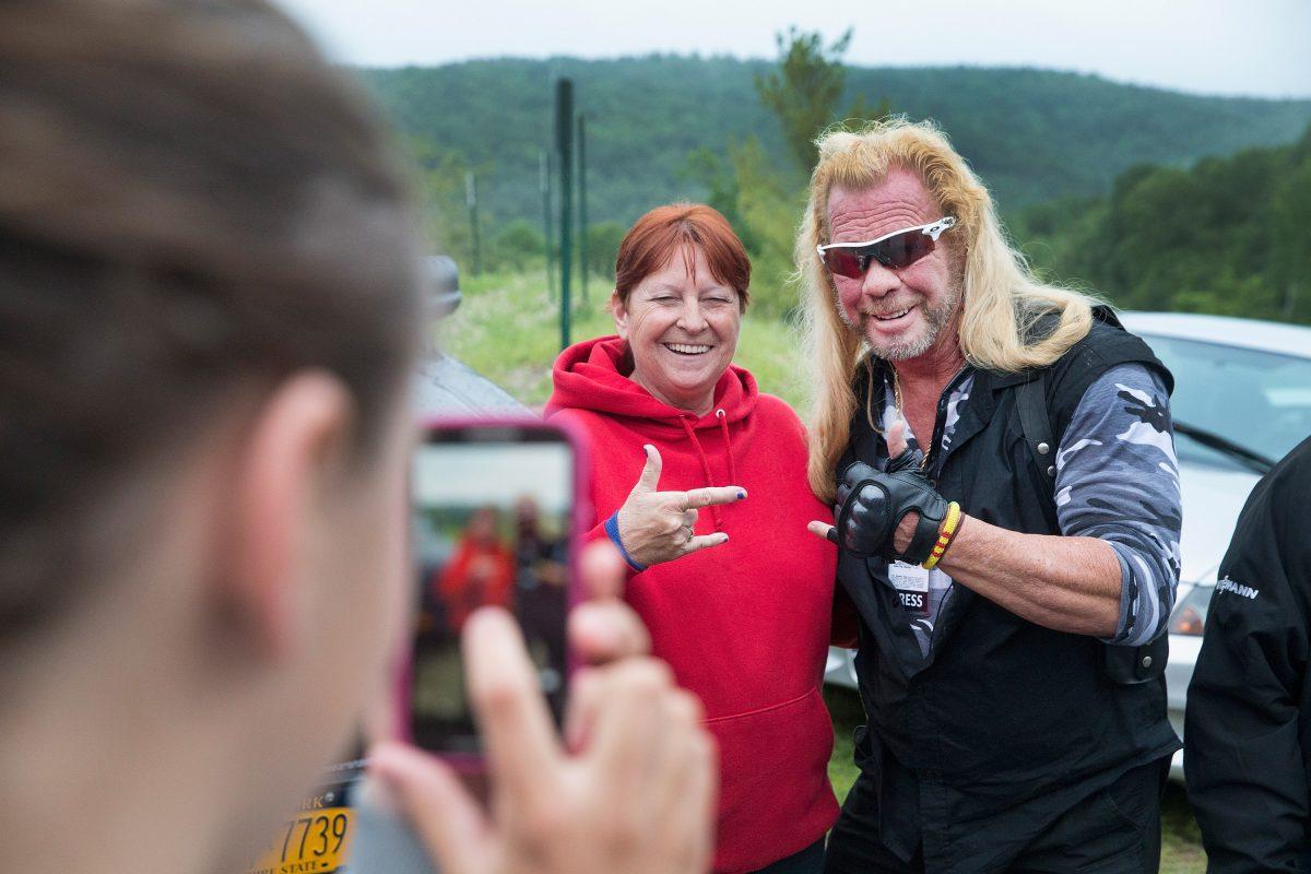 Dog the Bounty Hunter, Duane Chapman poses with a fan outside of a press conference where New York Governor Andrew Cuomo, was speaking to the media about the capture of convicted murderer David Sweat on June 28, 2015 in Malone, New York. (Photo by Scott Olson/Getty Images)