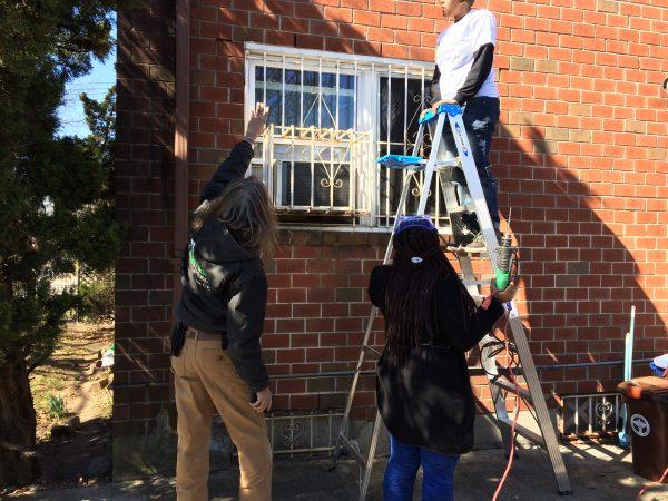 Terry Scott (L) assisting some volunteers. (Courtesy of Rebuilding Together NYC)
